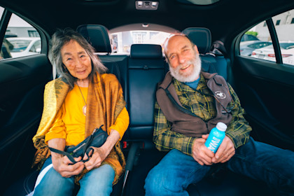 Eli's parents enjoying their ride in a Waymo autonomous vehicle.