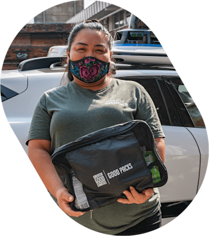 Greater Good partner in front of Waymo vehicle