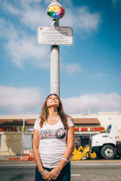 Lili standing under the Rainbow Halo, honoring her daughter and others killed by street racing.